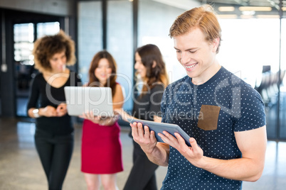 Man looking at digital tablet and smiling