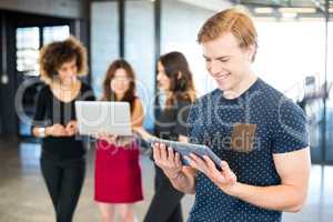 Man looking at digital tablet and smiling