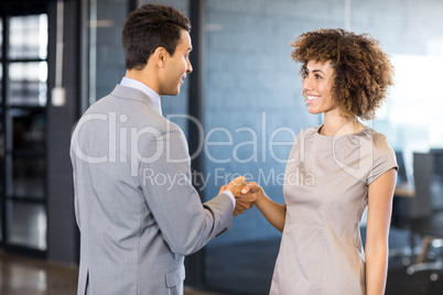 Businessman shaking hands young woman