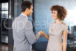 Businessman shaking hands young woman