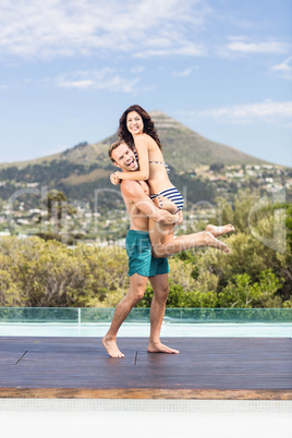 Young couple enjoying near pool