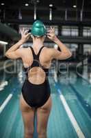 Pretty woman adjusting her bathing cap