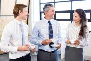 Businesspeople interacting in office during breaktime