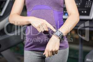 Pregnant woman pointing smart watch