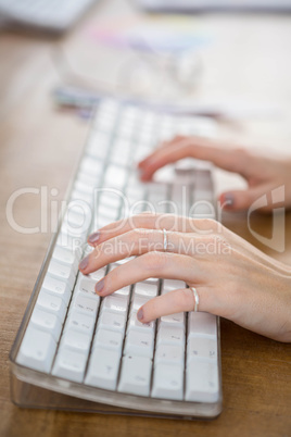 fingers typing on a computer keyboard