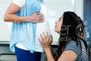 Woman touching pregnant partners stomach