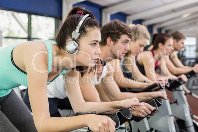 Fit group of people using exercise bike together