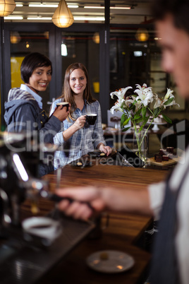 Smiling women having coffee