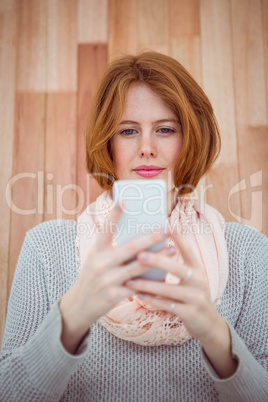Red haired hipster using smartphone