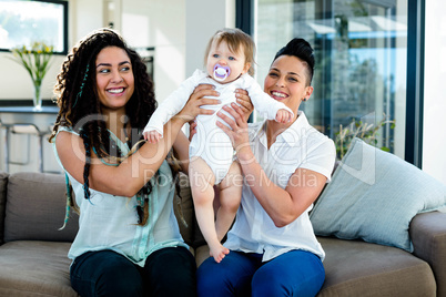 Lesbian couple playing with their baby