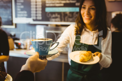 Waitress serving a cup of coffee