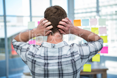 Worried hipster man in front of post-it