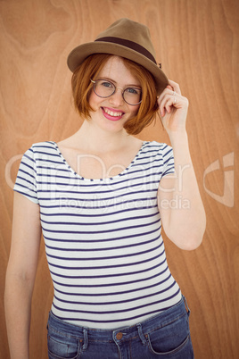 smiling hipster woman wearing a trilby