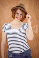 smiling hipster woman wearing a trilby