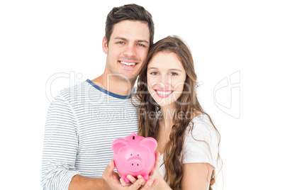 Couple holding piggy bank