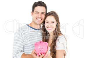 Couple holding piggy bank
