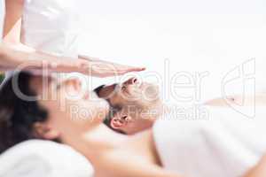 Couple receiving a head massage from masseur