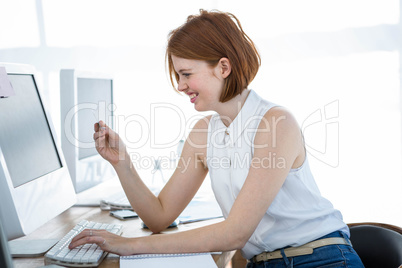 smiling hipster business woman inputting her credit card details