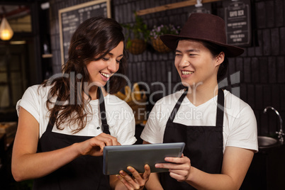 Smiling co-workers using tablet