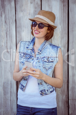 smiling hipster woman on her smartphone