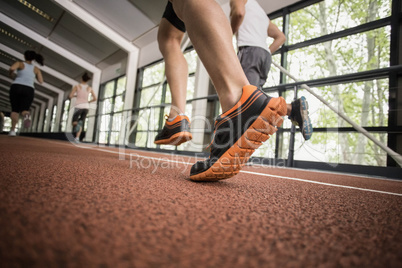 Four athletic women and men running