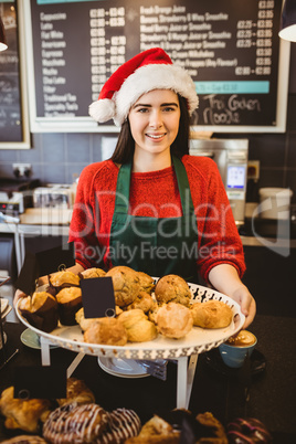 Cute waitress standing behind the counter