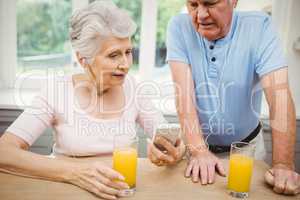 Happy senior couple listening to music