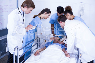 Doctors examining a patient on bed