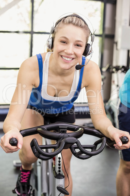 Fit group of people using exercise bike together