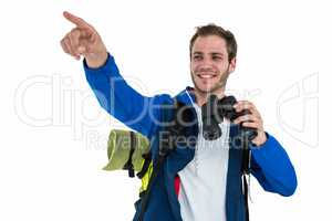 Backpacker hipster pointing while holding binoculars