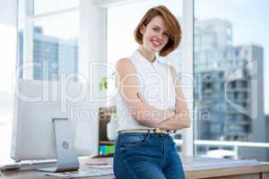 smiling hipster business woman with her arms crossed