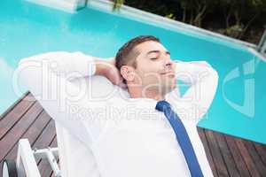 Smarty dressed man relaxing on sun lounger