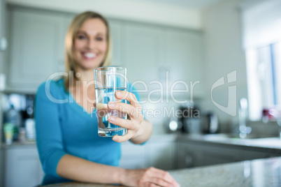 Pretty blonde woman drinking a glass of water