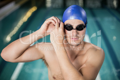 Fit man adjusting his goggles