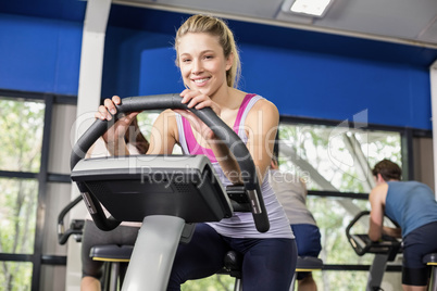 Fit woman doing exercise bike