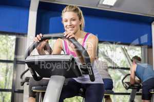 Fit woman doing exercise bike