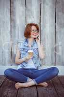 smiling hipster woman sitting on the phone
