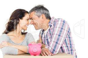 Couple with boxes and piggy bank