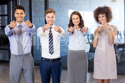 Portrait of confident business team pointing in office