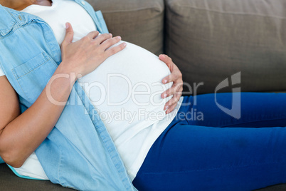 Pregnant woman touching her belly