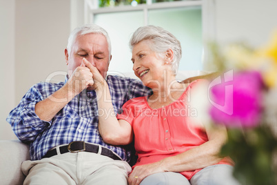 Senior man kissing womans hand