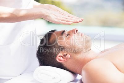 Man receiving a head massage from masseur