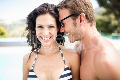 Young couple embracing each other near pool