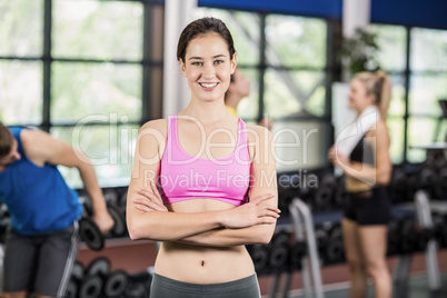 Fit woman posing with athletic women and man behind