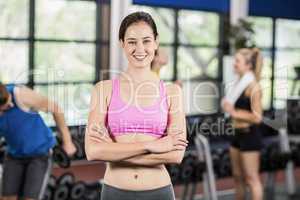 Fit woman posing with athletic women and man behind