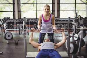 Trainer woman helping athletic man