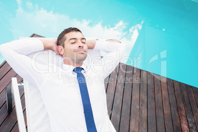 Smarty dressed man relaxing on sun lounger