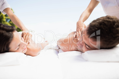 Young couple receiving a back massage from masseur