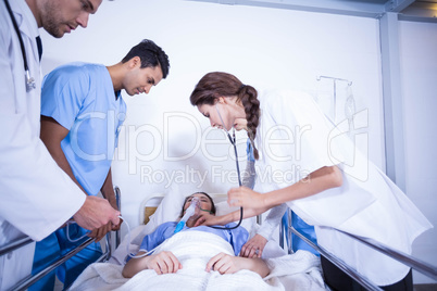 Doctors examining a patient on bed