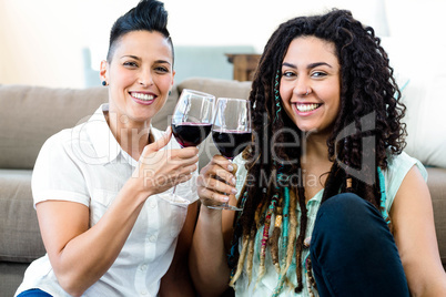 Lesbian couple toasting wine glasses